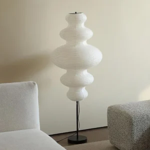 Modern Noguchi-inspired floor lamp in contemporary living room setting, minimalist home décor