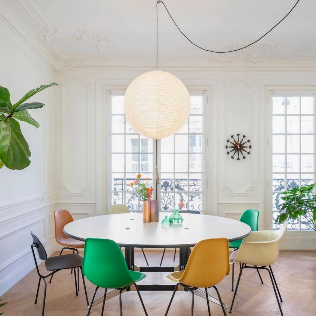 Single Akari A Series paper pendant lamp above elegant contemporary dining table with marble top