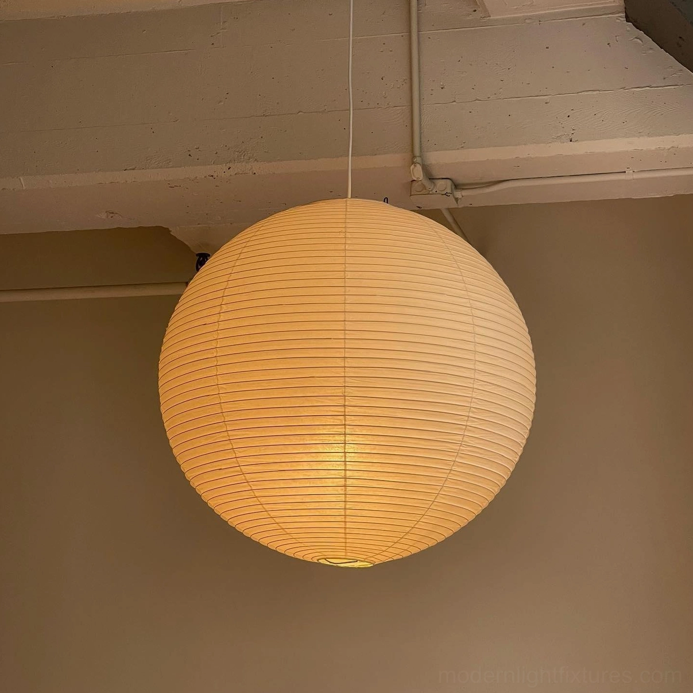 Illuminated Akari A Series pendant lamp in residential ceiling installation