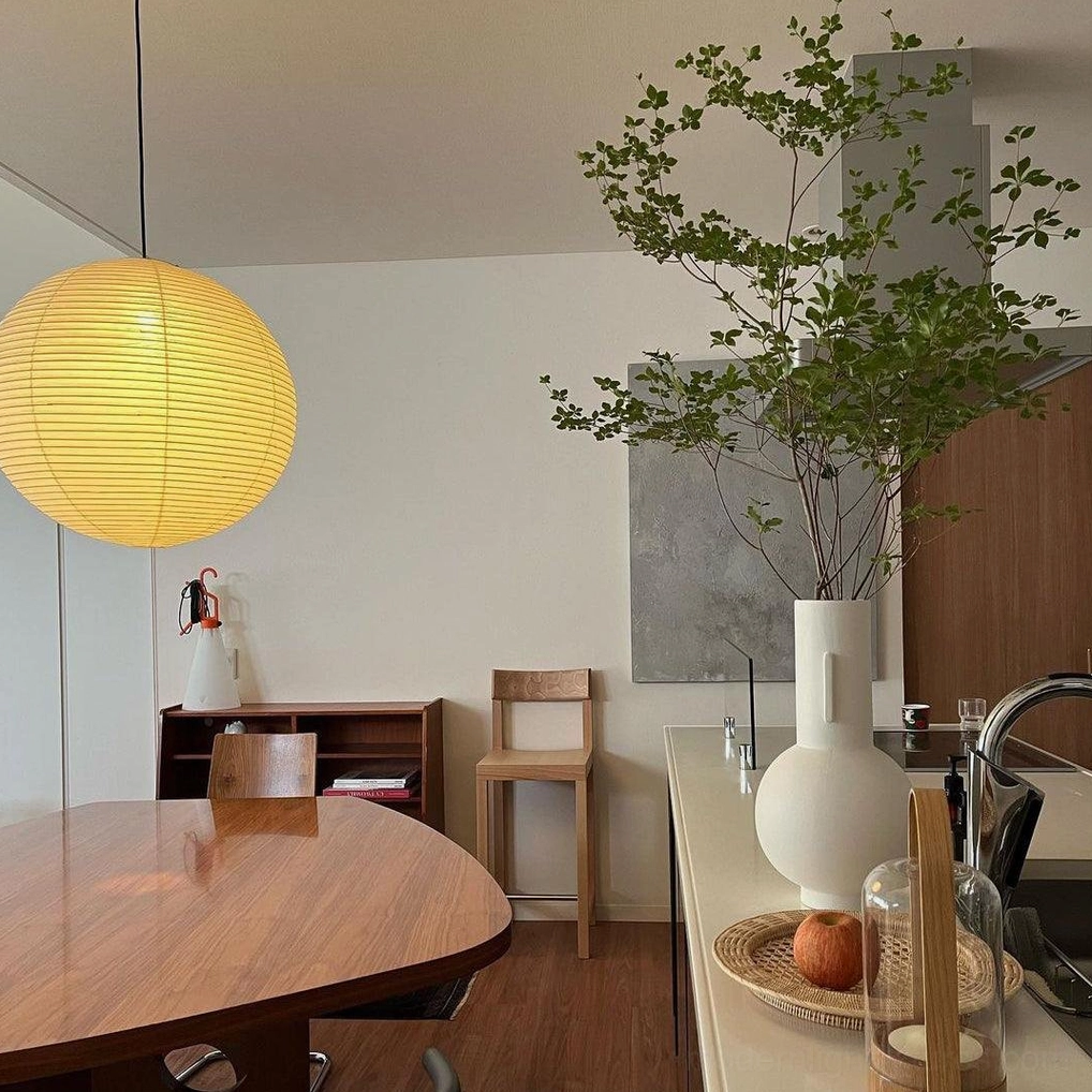 Akari Round 50cm pendant lamp creating soft diffused light over dining area