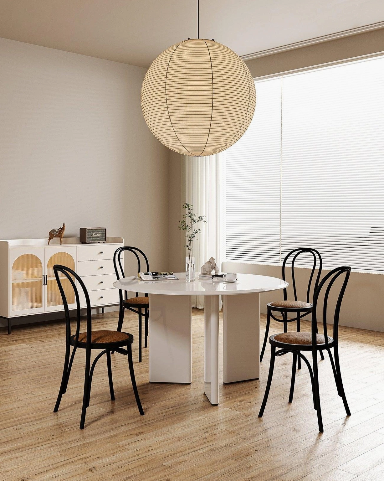 Akari Round pendant lamp above wooden dining table and chairs in minimalist Nordic dining space