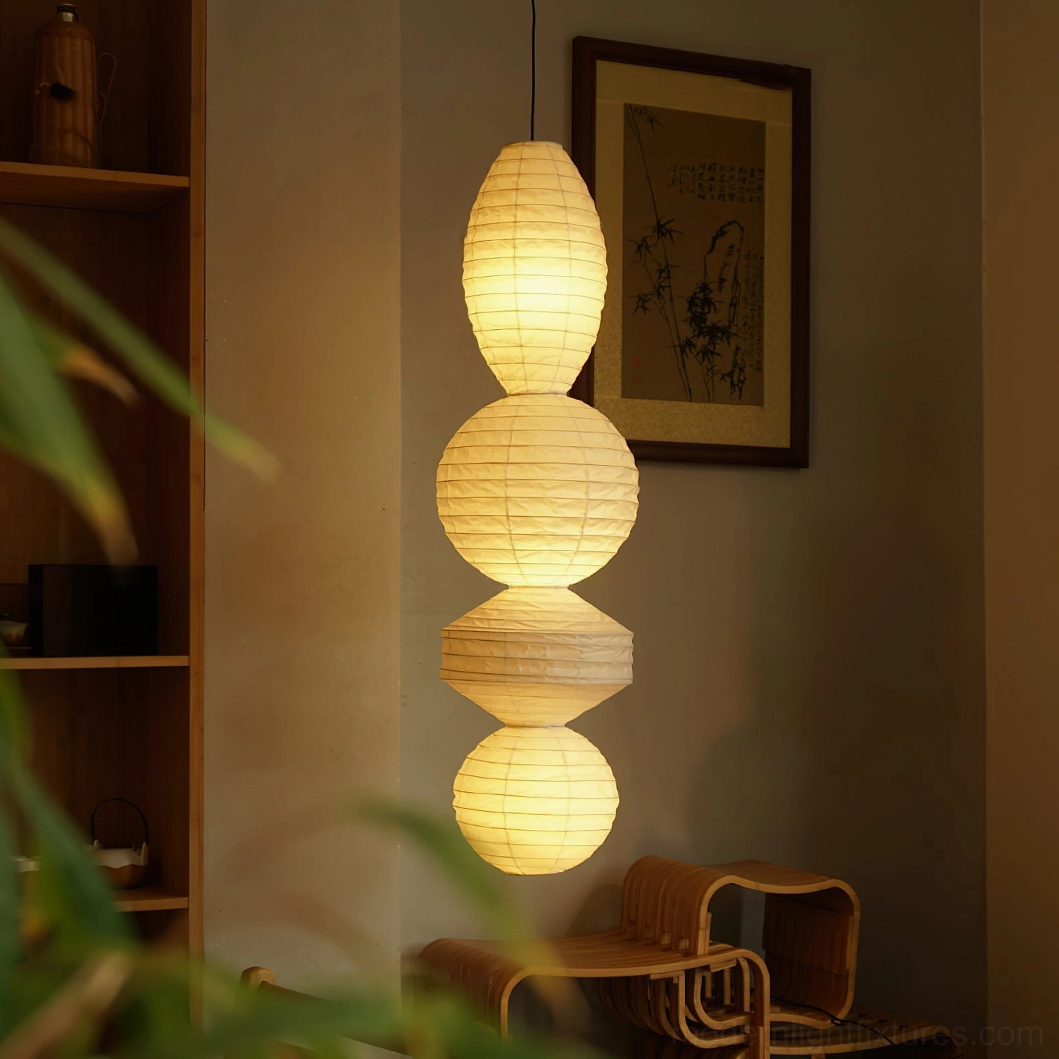 Akari Tayo pendant lamp glowing warm light in modern home corner, Japanese paper hanging fixture