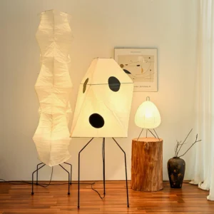 Three Akari UF3-Q Japanese paper floor lamps in living room corner with warm wooden flooring
