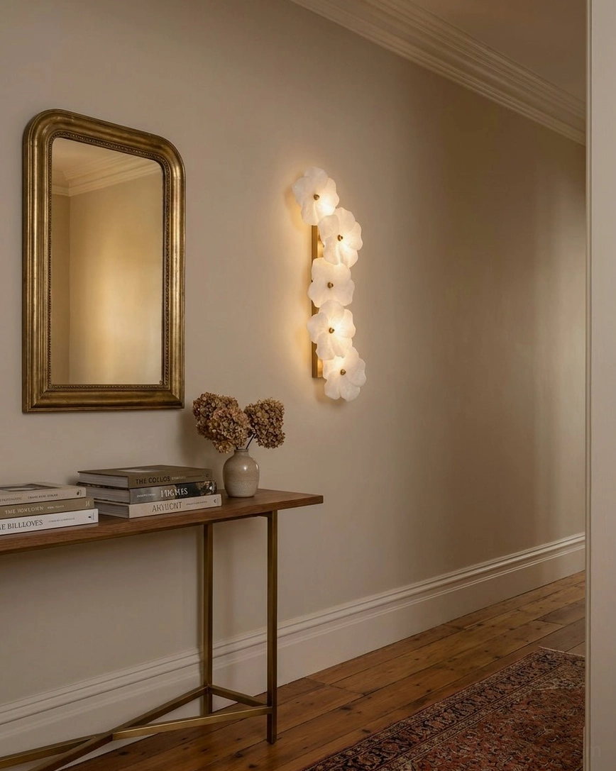Alabaster Bloom Wall Sconce mounted at eye level on luxury entryway console, brass centers glowing
