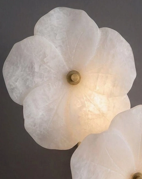 Alabaster Bloom Wall Sconce close-up detail, carved stone veining and brass center stud