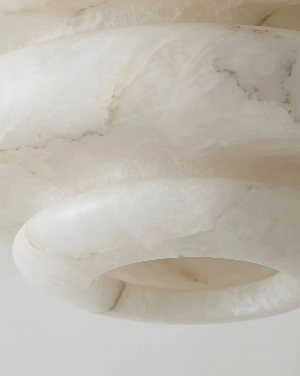 Alabaster tiered stone ceiling light in modern bedroom with linen bedding and warm ambient glow