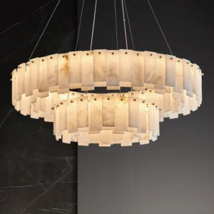 Close-up detail of two-tier alabaster chandelier showing natural stone veining and illuminated layers against dark marble background, modern luxury pendant lighting