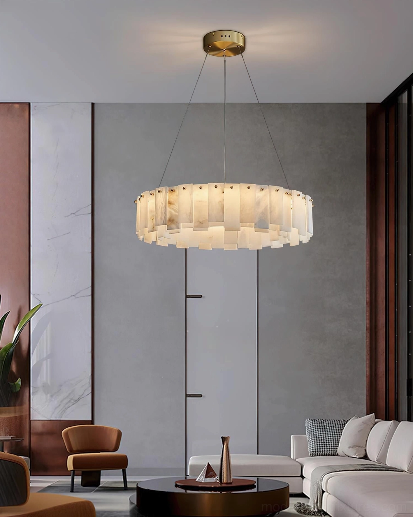 Alabaster chandelier hanging installation view showing adjustable brass cable, architectural stone light fixture suspended in contemporary residential space