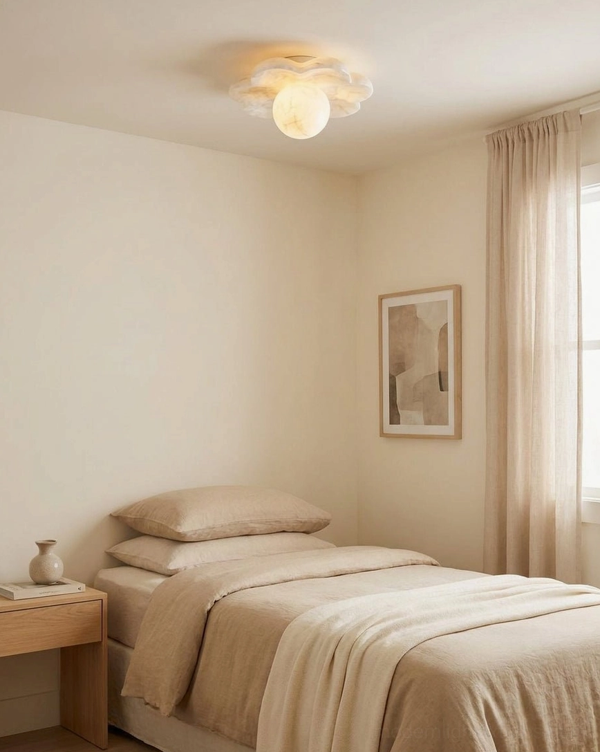 Natural alabaster flush mount ceiling light showing brass canopy mounting hardware and aged patina on warm neutral ceiling