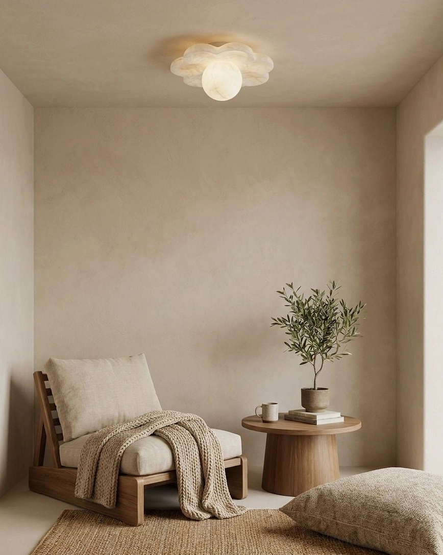Natural stone alabaster ceiling fixture in quiet lounge space with wooden chair, side table, and potted plant, calming ambient light