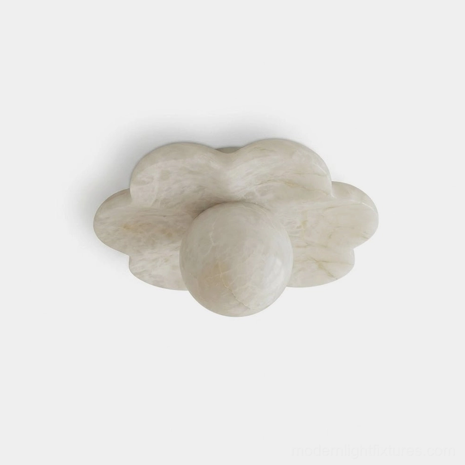 Carved natural alabaster flower flush mount ceiling light fixture with rounded petal lobes and brass canopy, top-down product view on neutral background