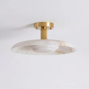 Selmora alabaster flush mount fixture, low-angle detail showing ribbed brass canopy and natural stone