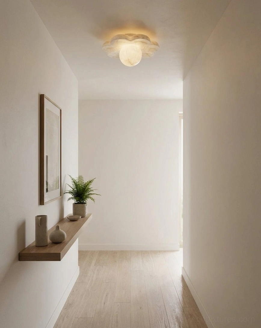 Carved stone flower ceiling fixture in minimalist hallway entryway with wooden flooring and neutral wall decor, soft ambient lighting