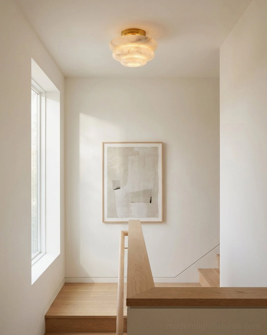 Tiered alabaster stone ceiling fixture overhead view emphasizing sculptural design and light diffusion