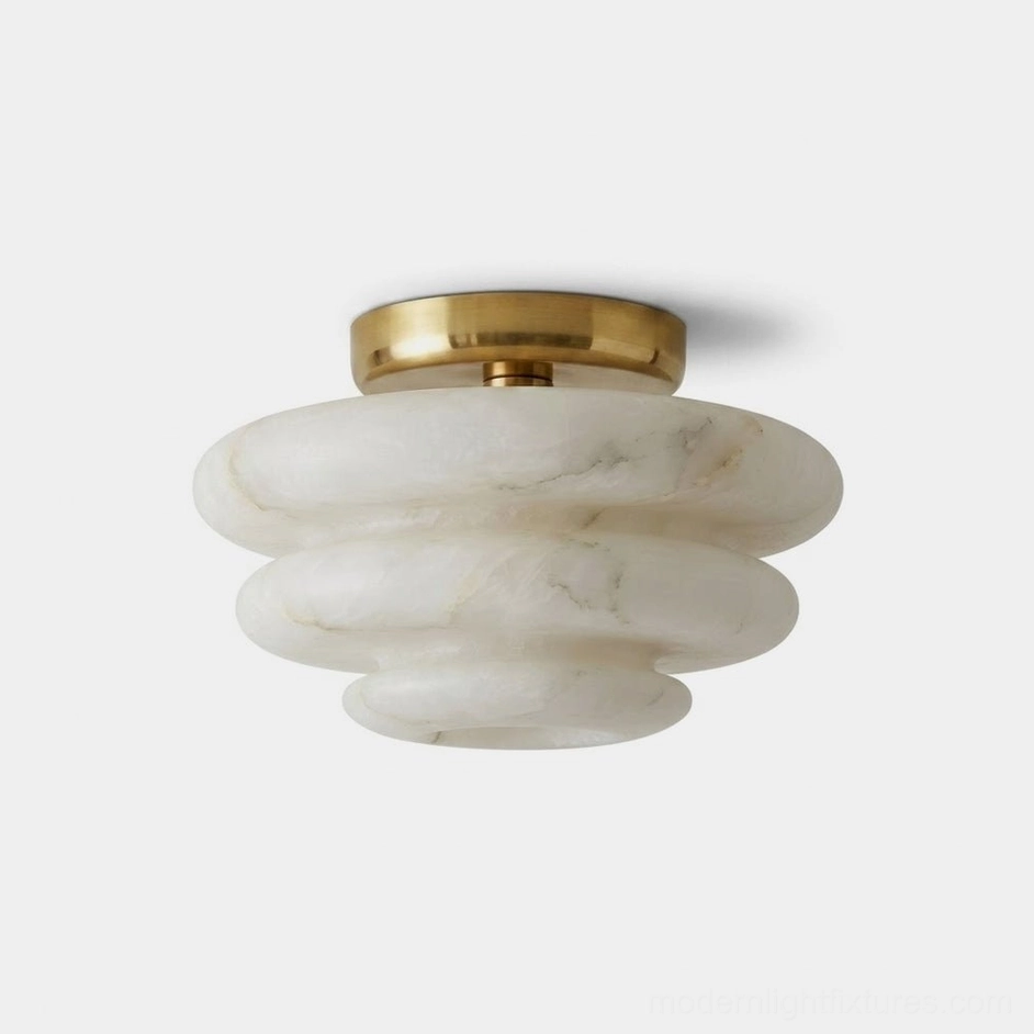 Alabaster flush mount ceiling light with tiered white marble stone shade and warm brass canopy, front product view