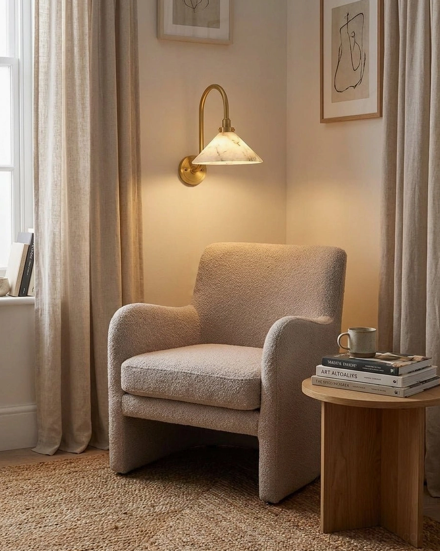 Lunelle alabaster gooseneck sconce in modern living room corner, eye-level beside upholstered armchair
