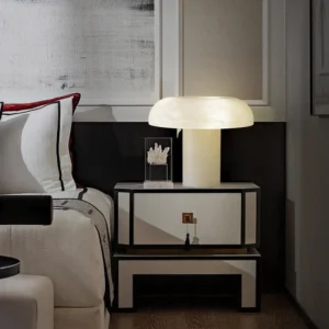 Modern alabaster bedside table lamp in master bedroom nightstand with warm ambient lighting