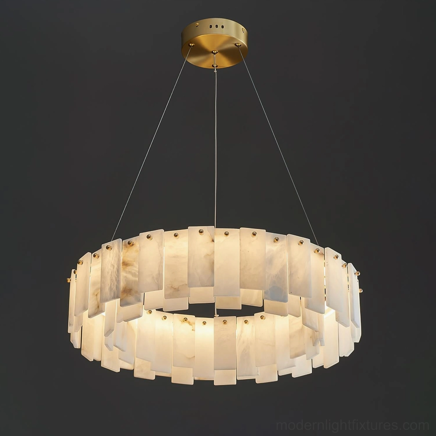 Alabaster light fixture detail showing natural stone translucency and warm illumination, mid-century modern inspired geometric pendant with brass suspension