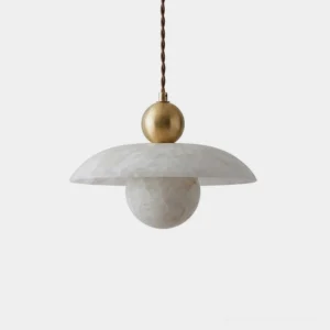 Natural alabaster pendant light with brass ball connector and twisted fabric cord, studio close-up showing stacked saucer and orb design