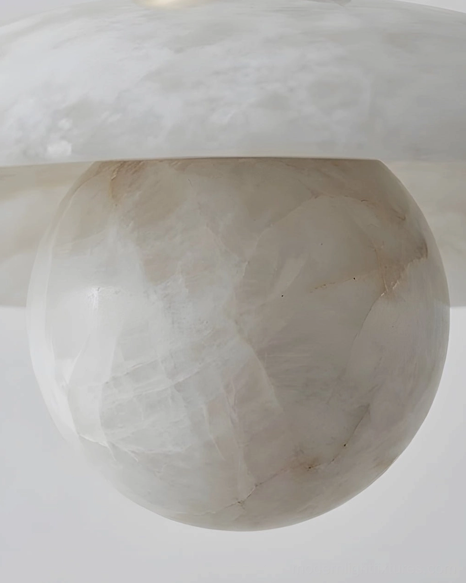 Alabaster pendant light suspended from twisted fabric cord showing sculptural form and translucent stone layers
