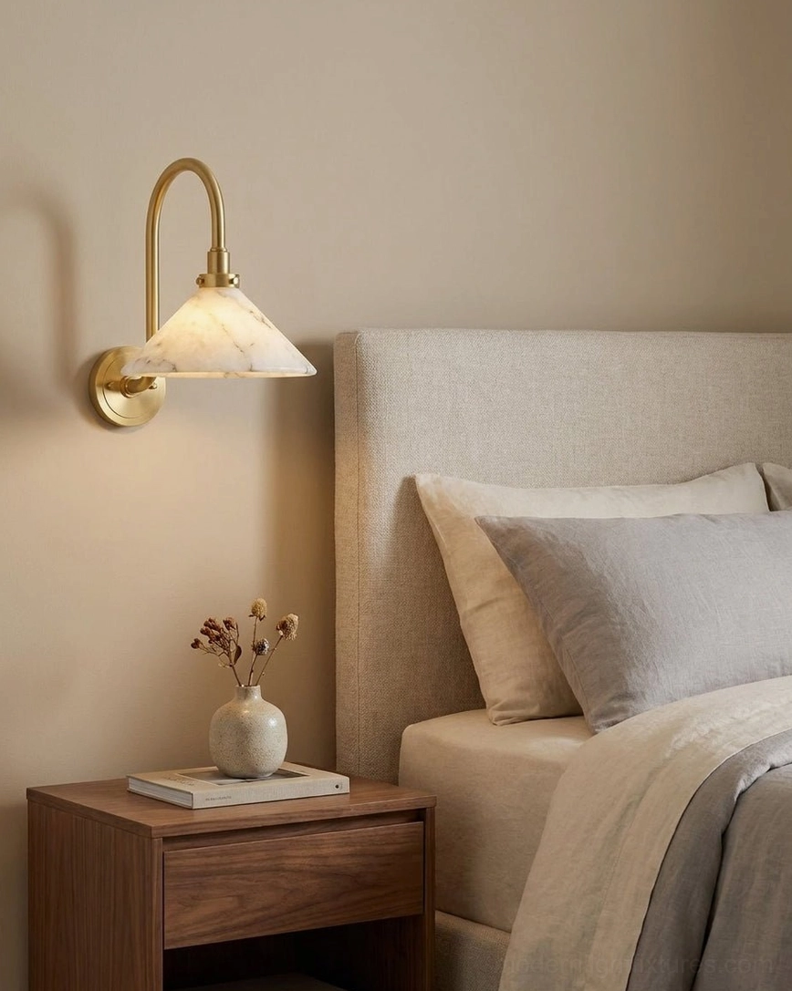 Lunelle alabaster wall sconce detailed view, sculptural cone shade and brass swan-neck arm