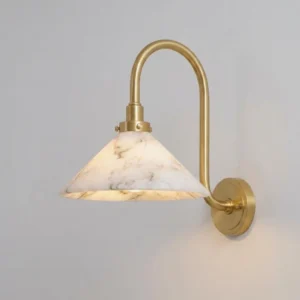 Lunelle alabaster wall sconce side close-up, polished brass arm and conical stone shade detail