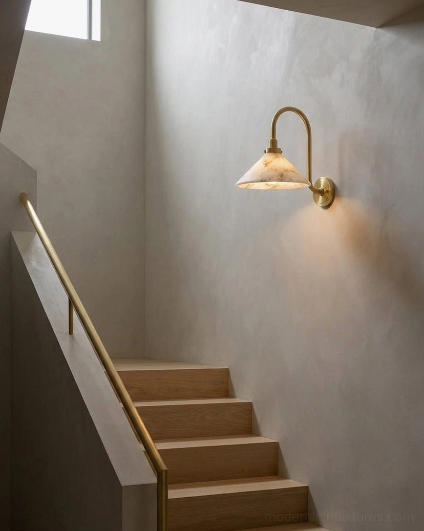 Lunelle wall sconce installed on textured plaster in residential stairwell, architectural lighting