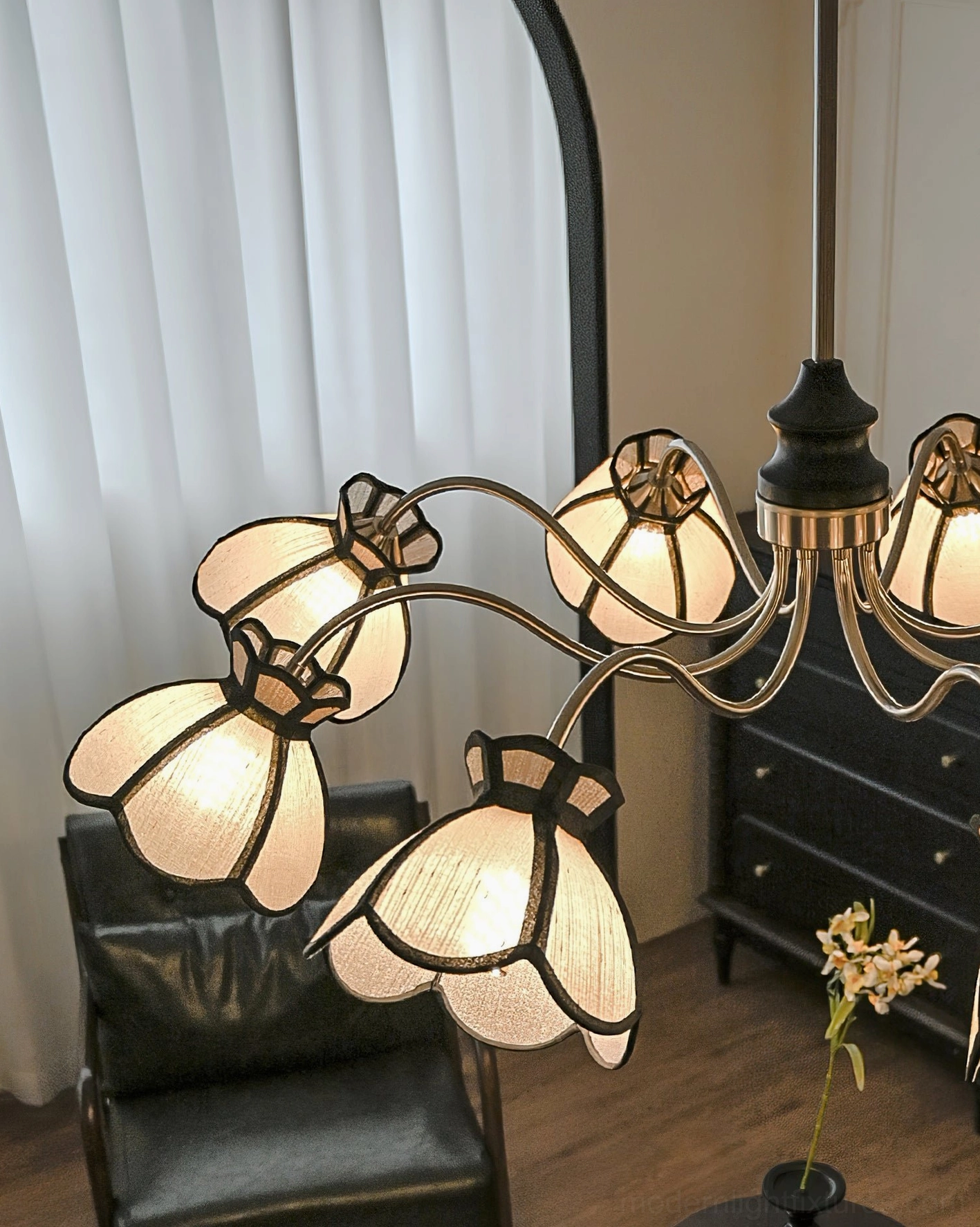 Side profile view of 6-head floral chandelier with vintage black metal frame in retro living room setting