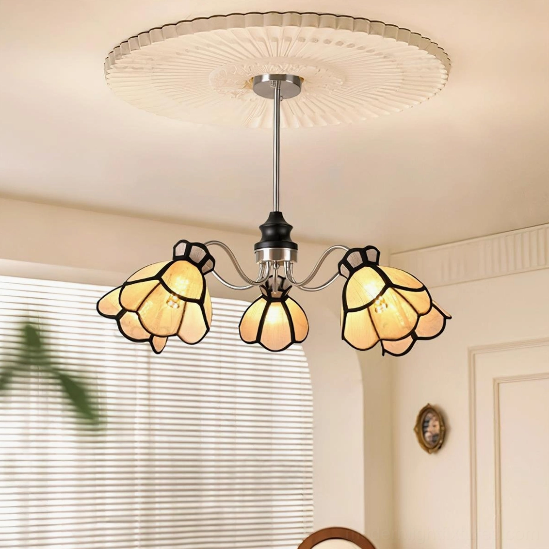 Low-angle upward view of 5-head flower chandelier installed with pleated ceiling rose showing warm ambient lighting effect