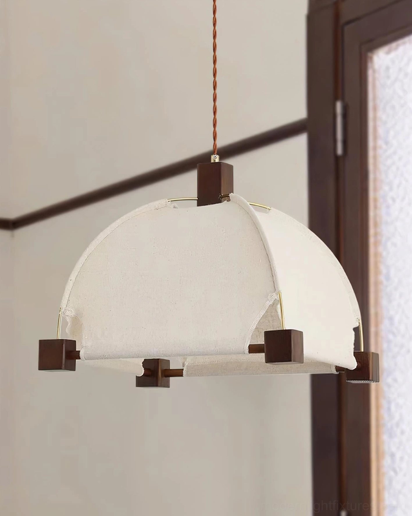 Contemporary Allegra pendant light suspended above dining table - minimalist modern design