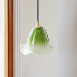 Green Aluna pendant lamp with matcha gradient glass shade and brass fixture, three-quarter view showing organic texture