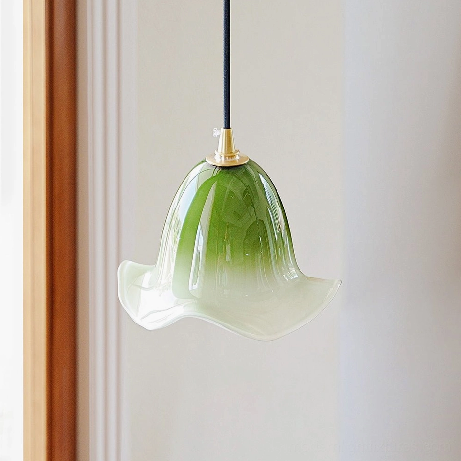 Green Aluna pendant lamp with matcha gradient glass shade and brass fixture, three-quarter view showing organic texture