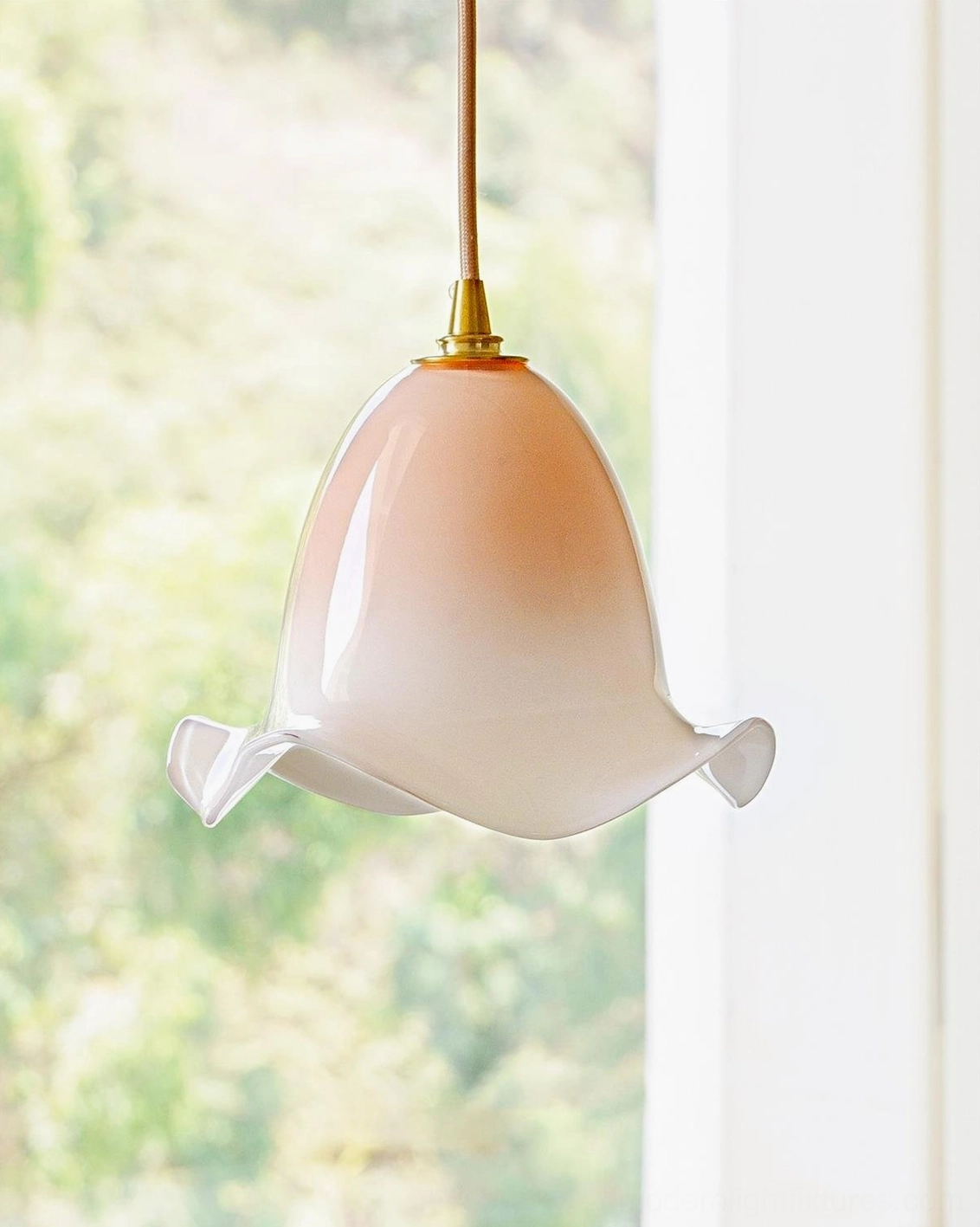 Pink gradient Aluna pendant light in sunlit interior space with greenery, showing soft natural light diffusion