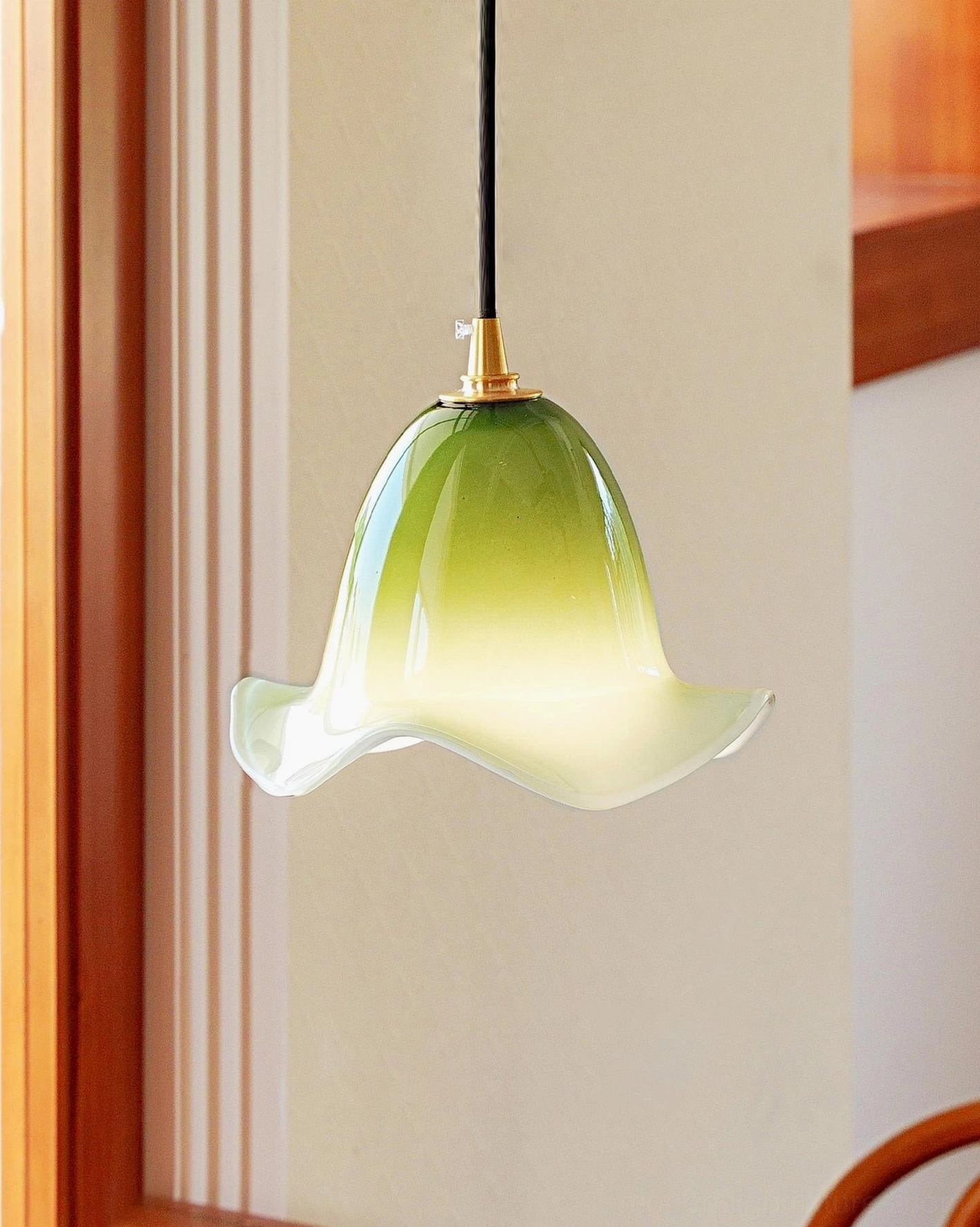 Aluna pendant light matcha green shade, three-quarter front view with brass lamp holder and black hanging wire