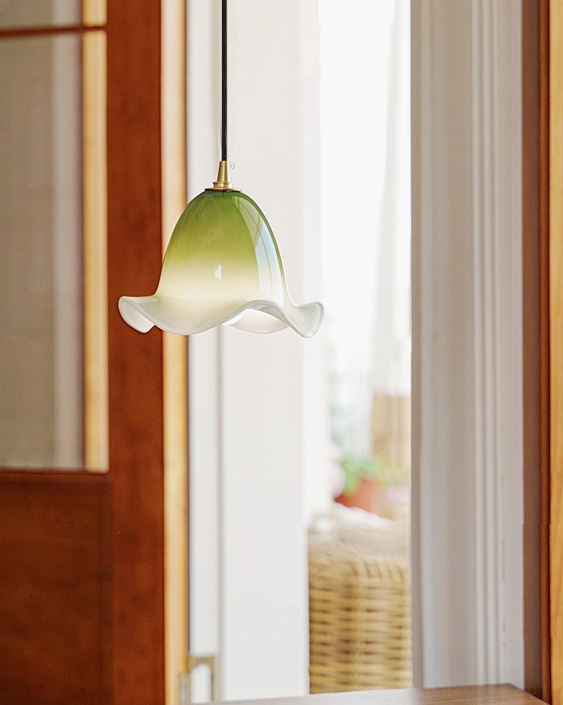 Aluna gradient glass pendant lamp in contemporary interior setting, showing ambient warm light effect