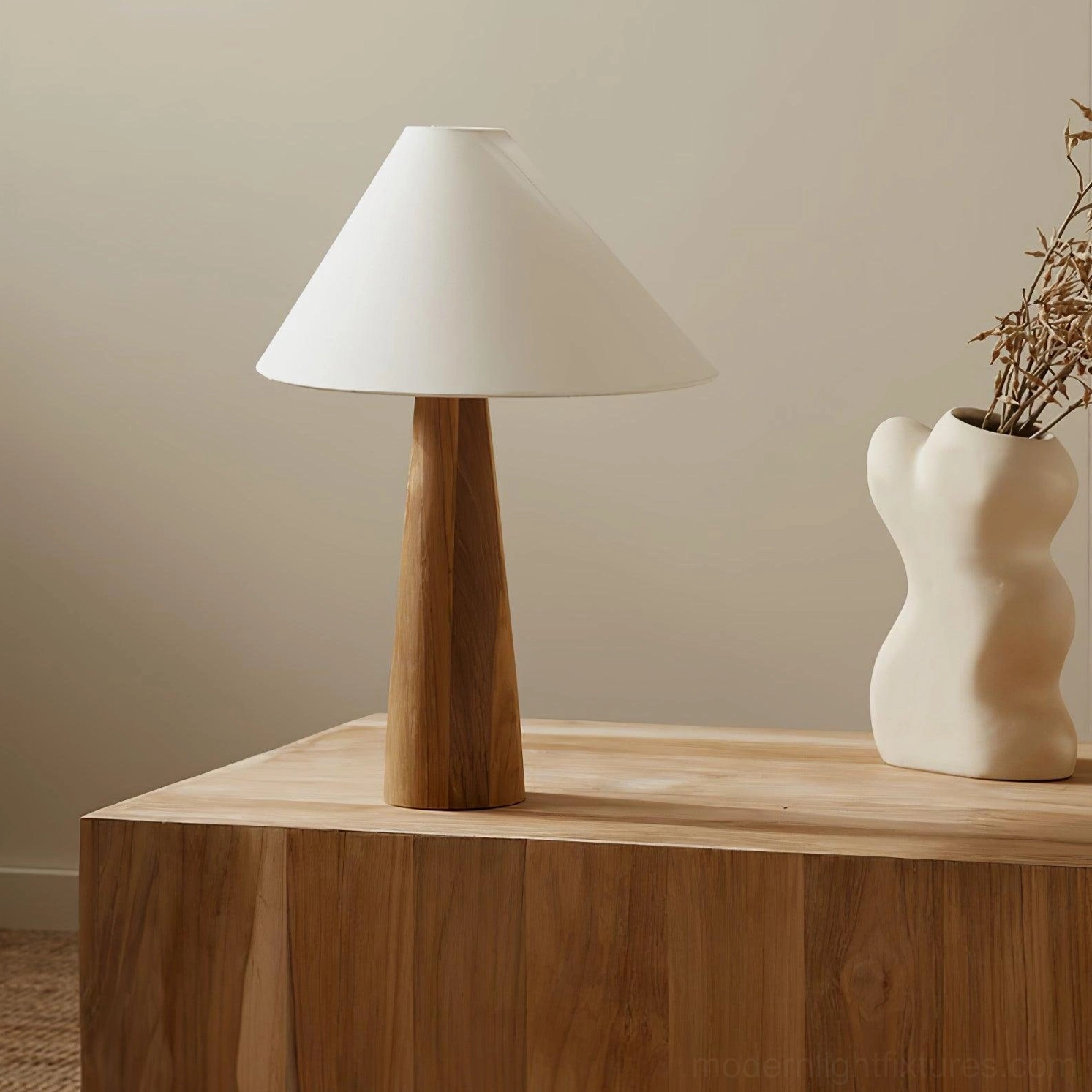 Contemporary Alvin lamp with tapered wooden pole and angled linen shade displayed on wooden cabinet