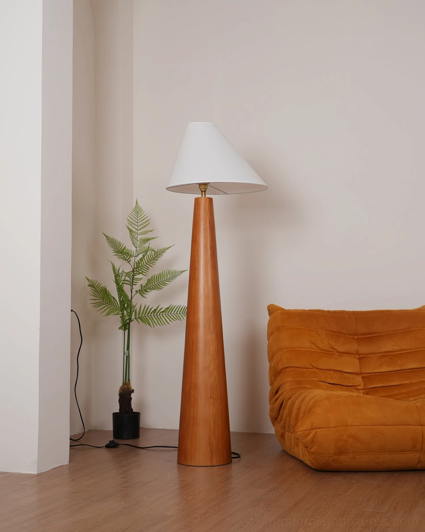 Alvin floor lamp in modern living room with organized power cord on wall, natural wood construction and white fabric shade unlit