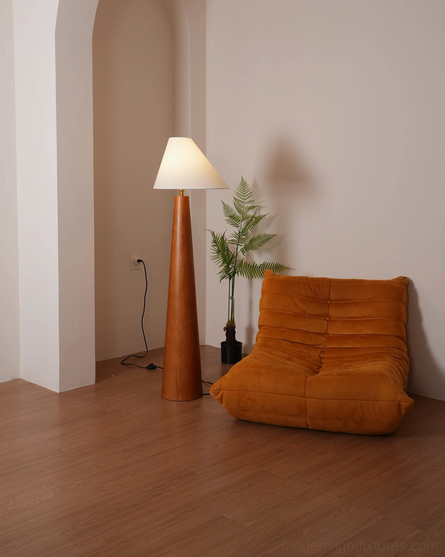 Modern floor lamp with solid natural wood tapered pole and white linen asymmetrical shade, studio quality product photography