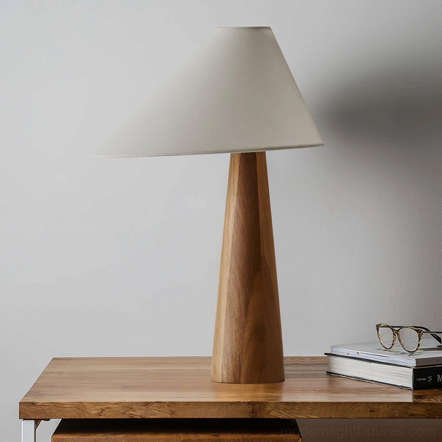 Alvin modern table lamp with warm wooden base positioned on side table with books and home accessories