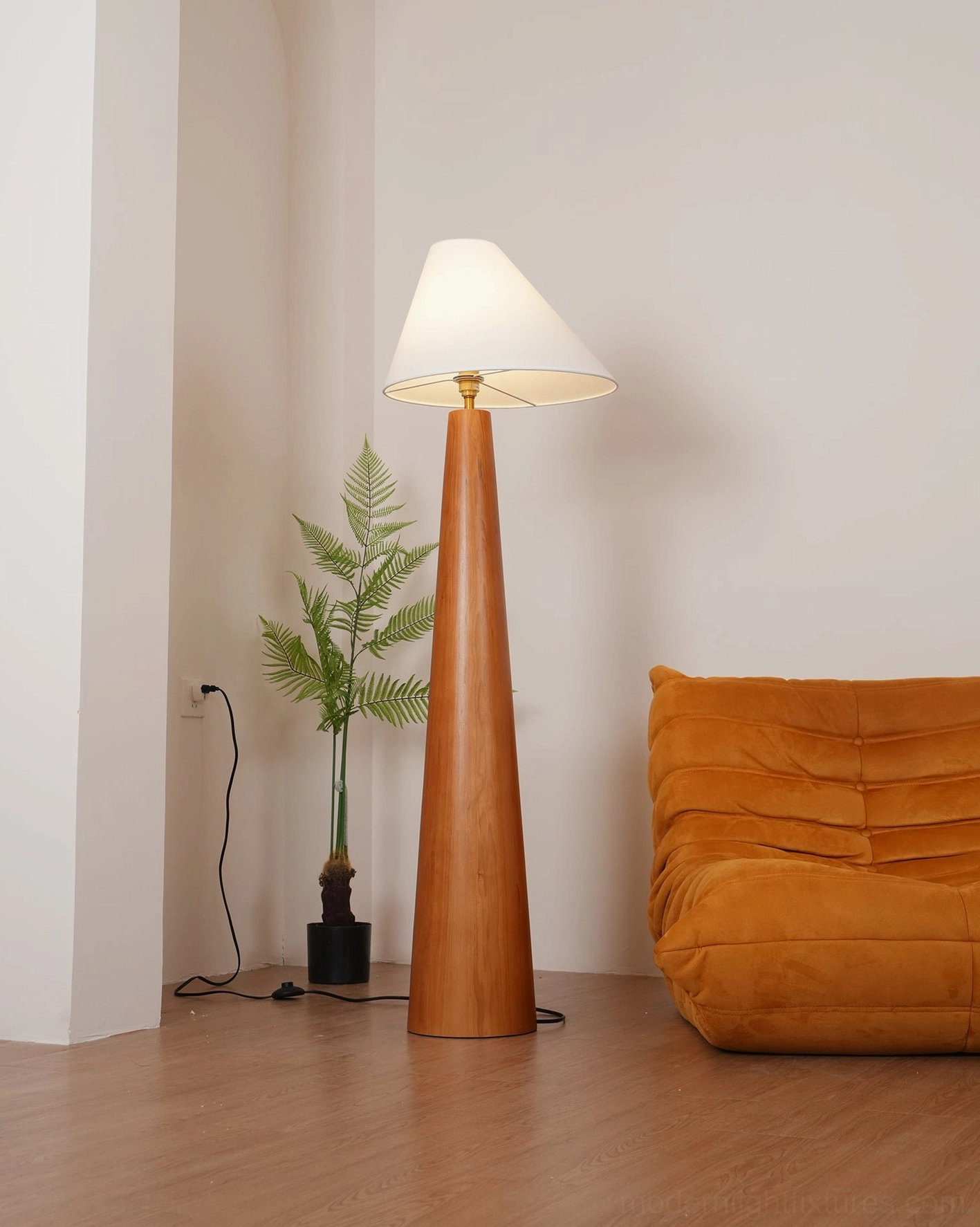 Modern wooden floor lamp in minimalist living room corner, unlit shade showing clean asymmetrical linen fabric design and natural wood pole