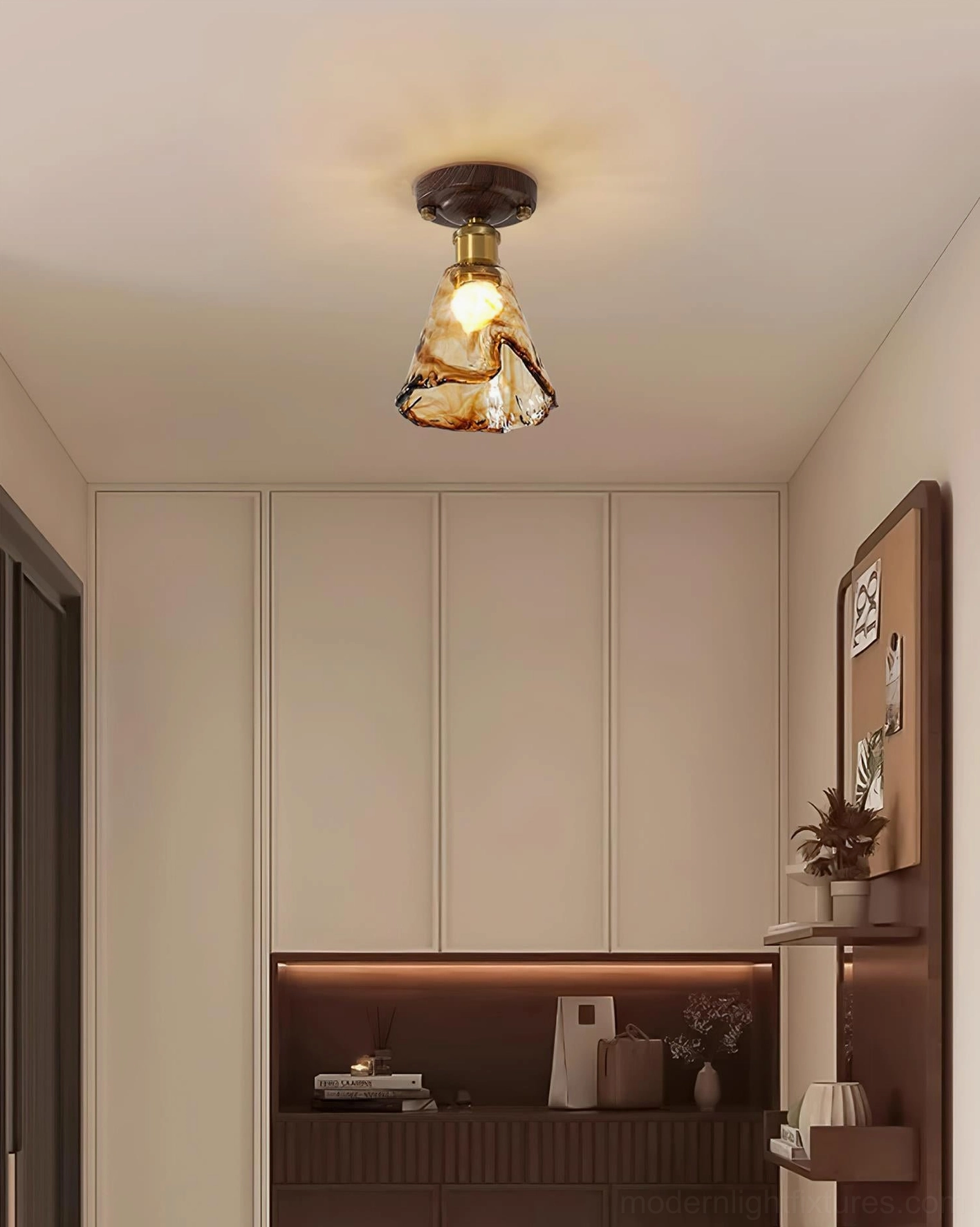 Amber ceiling light fixture mounted in modern home creating warm atmospheric lighting with brass and wood elements