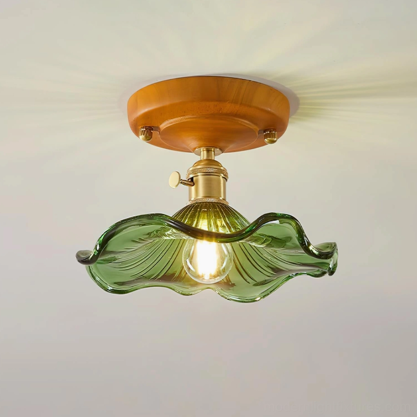 Illuminated amber wave glass ceiling light creating warm atmospheric glow and shadow patterns