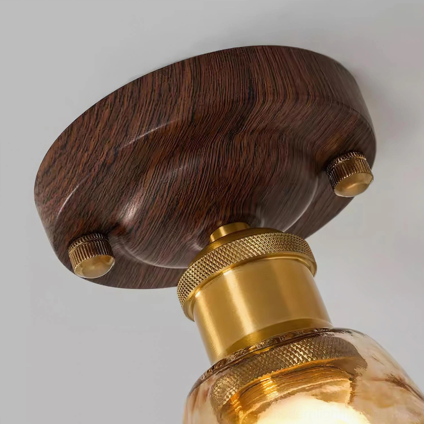 Amber glass ceiling fixture viewed from below - upward angle showing warm glow and light diffusion through molten glass