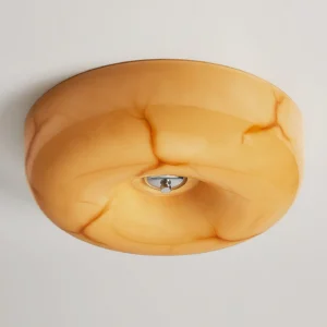Close-up detail of amber marbled glass diffuser and chrome ceiling light mounting base