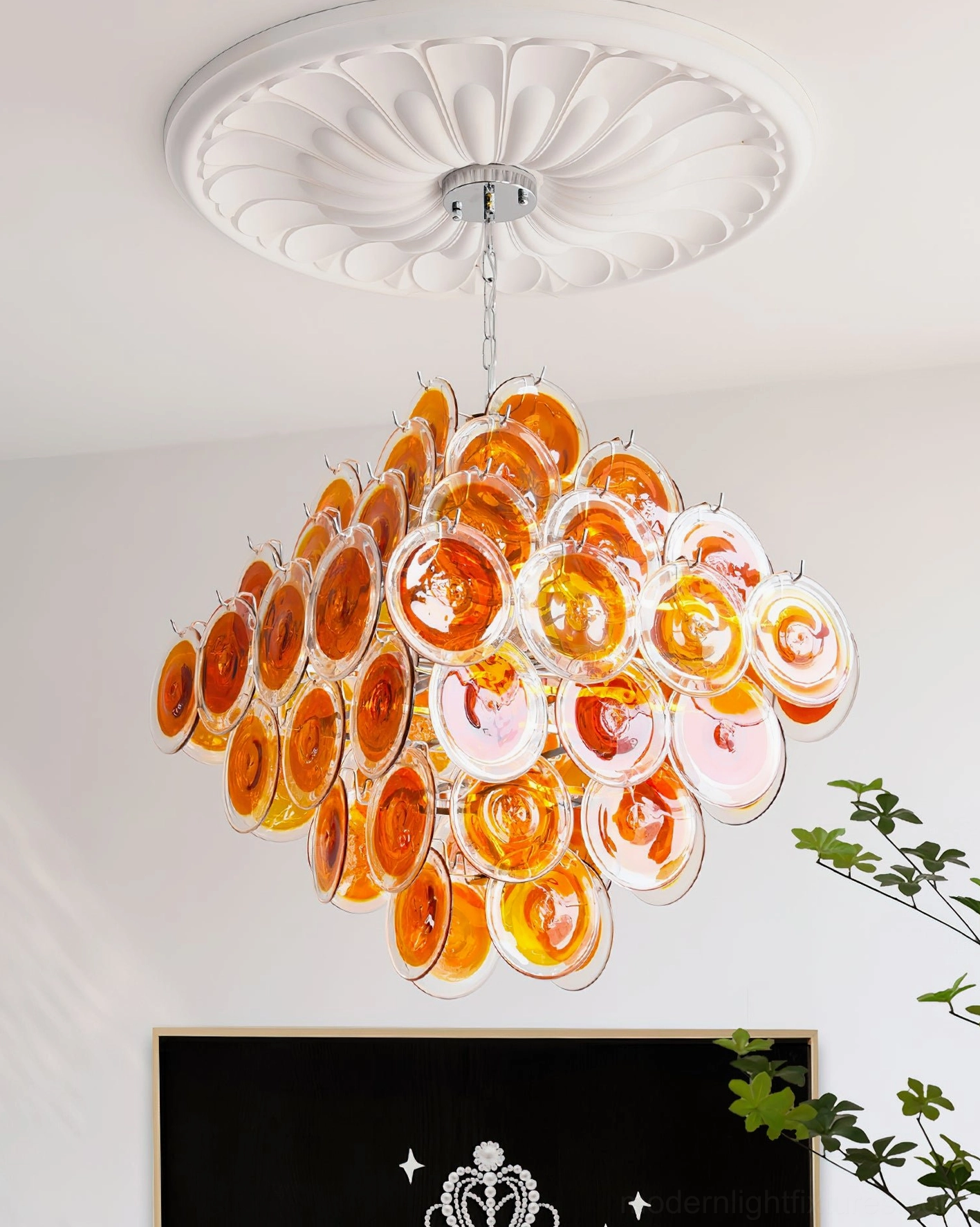 Amber glass disc chandelier interior design front view in fireplace lounge with dense round glass cluster and chrome suspension