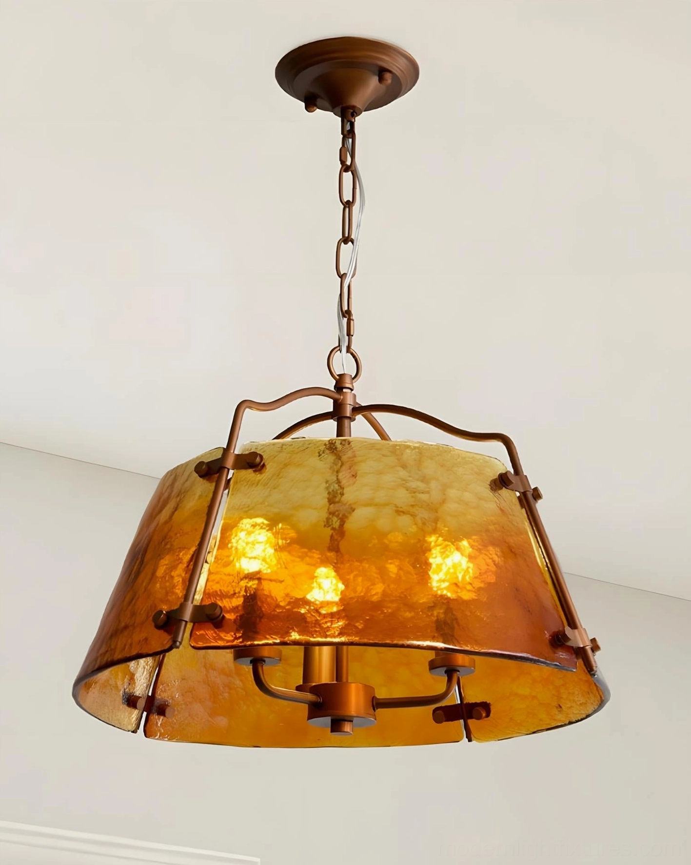 Amber glass pendant chandelier with exposed candle-style bulbs and brown metal hardware, front direct view