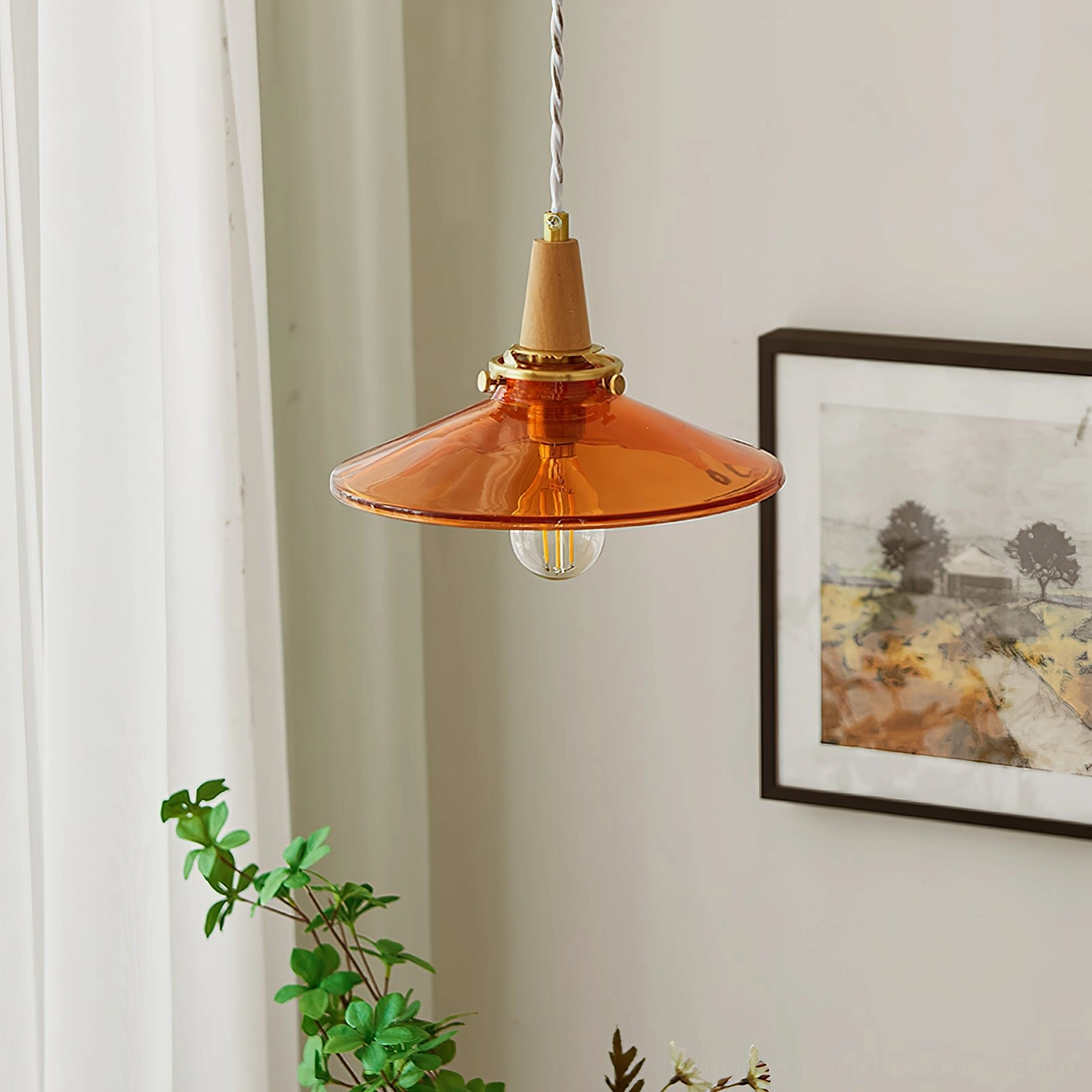 Amber glass pendant lamp installed in residential corner, showing warm glow with exposed Edison filament bulb