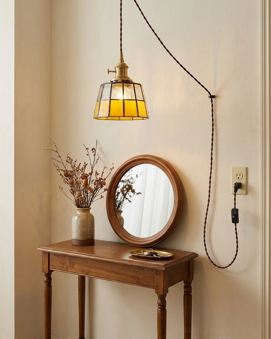 Warm amber stained glass pendant hanging above wooden vanity table in bedroom retro vintage makeup area with soft golden glow