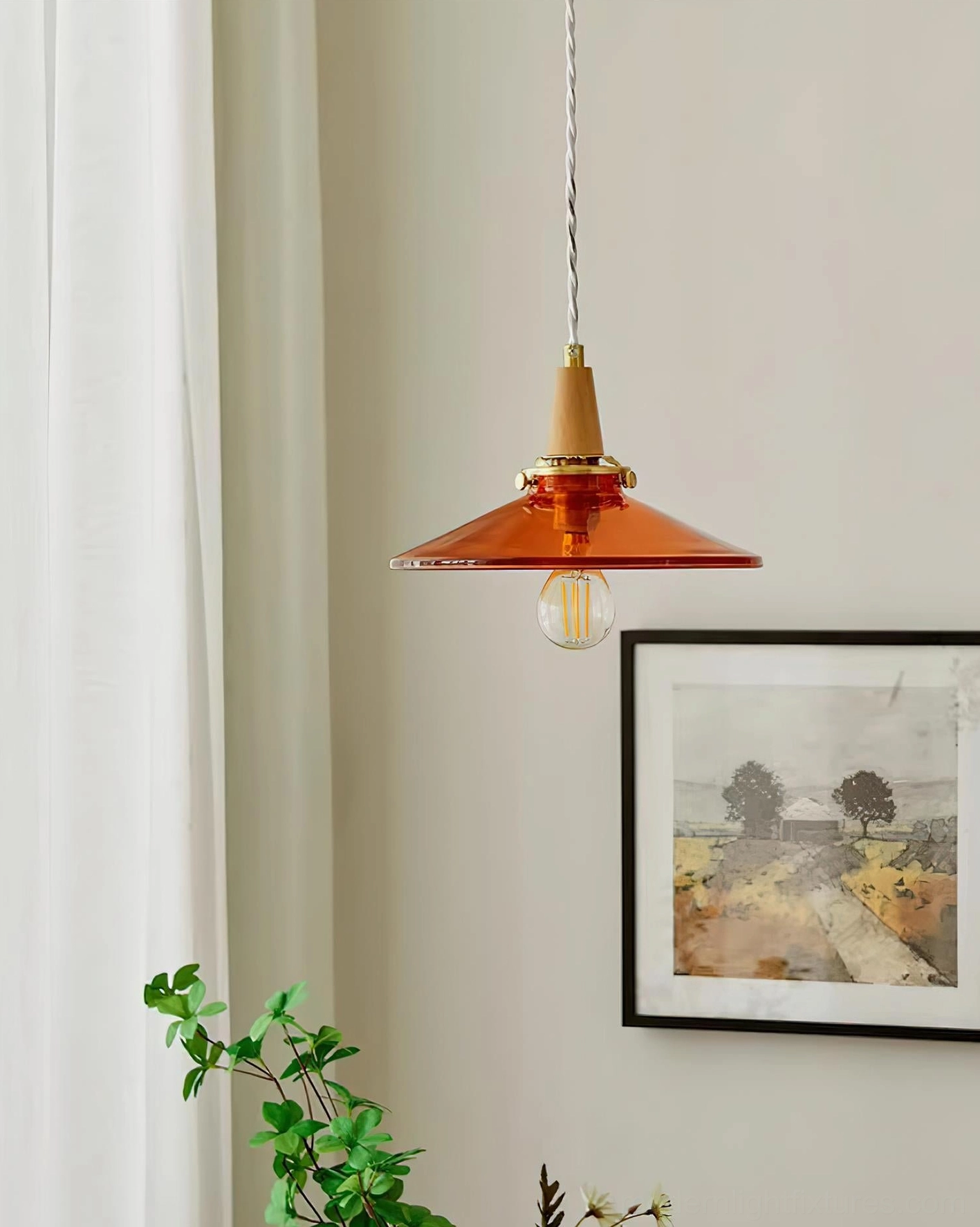 Amber glass pendant light with natural wood and brass accents showing vintage industrial design aesthetic