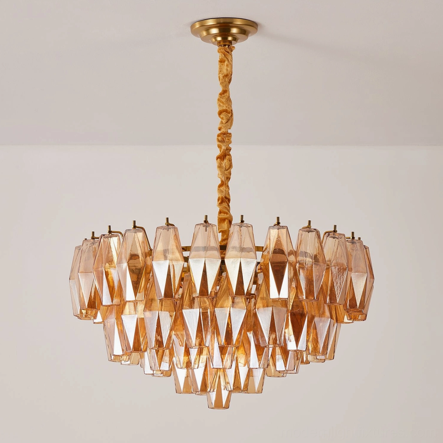 Amber hand-blown glass tiered chandelier with brass suspension rod, eye-level unlit interior view